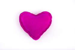 Table top shot of pink heart on white background