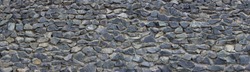 Panoramic texture of gray stonewall