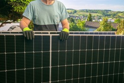 Solar panel in the hands of a worker.Smart consumption and energy saving. Fitting and installation of solar panels.Green energy.alternative energy from nature.Purchase of solar panels