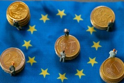 economy in in European countries.Figures of men in suits on euro coins on european union flags. Economic and political elite of Europe.Budgets and finances of the EU countries.