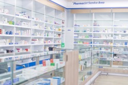 At chemist, Medicines arranged in shelves, Pharmacy drugstore retail Interior blur abstract background with healthcare product on medicine cabinet.