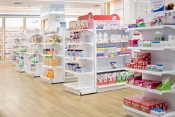 At the chemist, Medicines arranged in shelves, Pharmacy drugstore retail Interior blur abstract background with medicine healthcare product on cabinet with neon light.