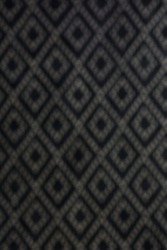 Diamond shape background, Seamless harlequin or argyle pattern made of black diamonds over white. Grid, mesh, lattice background with rhombus, diamond shapes. Blurry texture. Monochrome. 