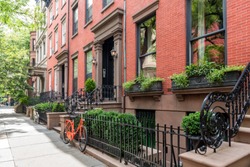 Two bicycles in front of a brownstone building in neighborhood of Brooklyn Heights, New York