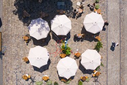 Aerial view on umbrellas in outdoor cafe in Lviv, Ukraine from drone