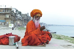 Sadhu at the ghats in Varanasi, India. With a pink beard from the traditional holi festival.