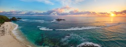 Panoramic view of tropical beach with surfers at sunset, Kuta, Lombok island. Indonesia