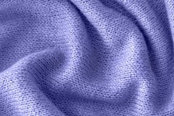 Color of the year 2022 soft knitted sweater texture closeup. Light violet blue abstract background. Trendy soft blue backdrop for web design. Luxury twisted fabric backplate 