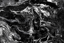 Acrylic paint abstract background. Mixture of white, black and golden paints making mysteries backplate. Pattern made by swirls of oil painting imitating marble texture