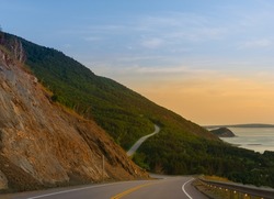 View of the Cabot Trail in Cape Breton Highlands National Park, Nova Scotia, Canada at dusk on a summer day