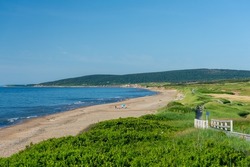 Scenic view from the sand dunes of the beach in the town of Inverness, Cape Breton Island, Nova Scotia. The walkpath is visible.