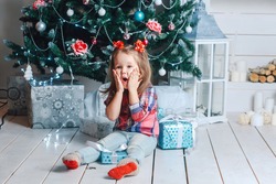 little girl surprised Christmas presents for the New Year