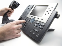 Making a call, man is dialing IP telephone keypad