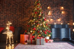 Christmas, New Year interior with red brick wall background, decorated fir tree with garlands and balls, dark drawer and deer figure