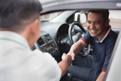 driver and friend or customer shake hand