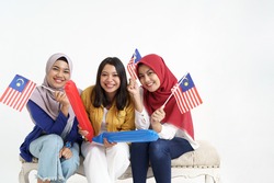 malaysia woman friend holding flag celebrating independence day together