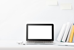 portrait of working desk with laptop, gadget, and books with copy space on white background