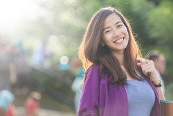 A portrait of a beautiful asian woman smiling brightly at the camera