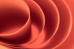 Abstract colored macro background, created with curved red paper sheets. Curved lines and shapes and soft vivid colors.