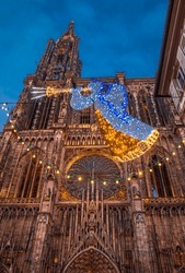 Evening view of Strasbourg Cathedral with illuminated Christmas angel