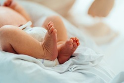 New Born Baby Feet on White Blanket In Hospital
