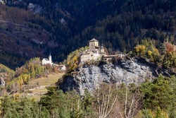 Ortenstein Castle (built in 1250) and the Cathlic church Tomlis near the Swiss village Domleschg in Canton Graubuenden, Switzerland