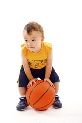 Adorable baby  boy playing with a basketball isolated over a white background