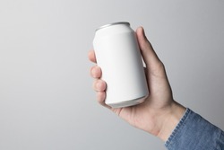 Blank Can in hand on white background, ready to replace your design.