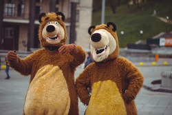 two men in a bear costume in the city, in day of protection of animals, festive entertainment