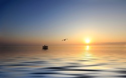 Sunrise over the Ionian sea with fishing boat on Zakynthos island Greece