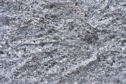 Crumpled aluminium foil texture close up background. Aluminium. Silver aluminium foil with shiny crumpled of aluminum paper background. Aluminium prices hit a record high.