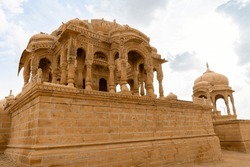 The royal cenotaphs of historic rulers, also known as Jaisalmer Chhatris, at Bada Bagh in Jaisalmer, Rajasthan, India. Cenotaphs made of yellow sandstone