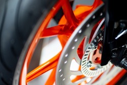 Details about motorcycle wheels, alloy wheels, disc brakes, silver and orange-black tones.