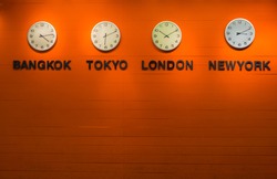 wall clock for to indicate world international time zone. in orange wood backgrouds