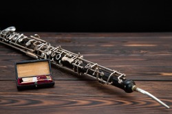 musical instrument, on the table lies an English horn with a reed 