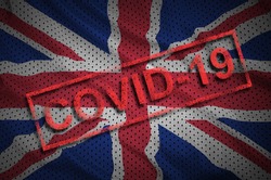 Great britain flag and red Covid-19 stamp. Coronavirus 2019-nCov outbreak