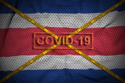 Costa Rica flag and Covid-19 stamp with orange quarantine border tape cross. Coronavirus or 2019-nCov virus concept
