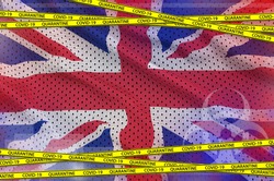 Great britain flag and Covid-19 quarantine yellow tape. Coronavirus or 2019-nCov virus concept