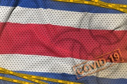 Costa Rica flag and Covid-19 biohazard symbol with quarantine orange tape and stamp. Coronavirus or 2019-nCov virus concept