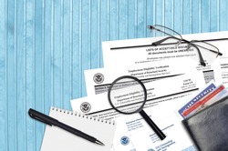 USCIS form I-9 Employment eligibility verification lies on flat lay office table and ready to fill. U.S. Citizenship and Immigration services paperwork concept. Top view