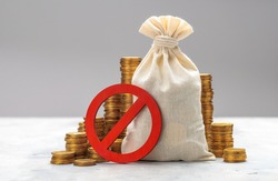 Prohibition sign. Money bag and stacks of coins on a gray background. No symbol and money.
