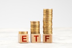 ETF fund. ETF management with stocks and bonds. Gold coins in pile as symbol of profit.