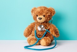 Pediatrics. Teddy bear with a stethoscope. Teddy bear on a green background.