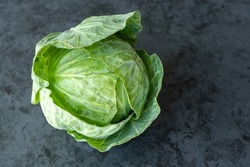 Fresh early cabbage on a dark background