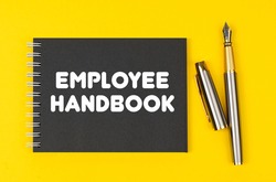 Business and finance concept. On a yellow background lies a pen and a black notebook with the inscription - Employee Handbook