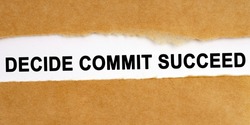 Education concept. There is a gap in the middle of the craft paper, inside of which there is an inscription on a white background - Decide Commit Succeed