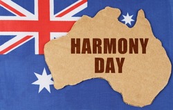 National concept of Australia. On the flag of Australia lies the contour of the map of the country with the inscription - Harmony Day