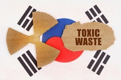 The concept of industry and radiation. On the flag of South Korea, the symbol of radioactivity and torn cardboard with the inscription - Toxic waste