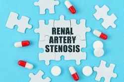 Medical concept. On a blue background, pills, capsules and puzzles with the inscription - Renal artery stenosis