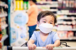 Virus mask Asian boy wearing face protection in prevention for virus in  supermarket,Thailand. COVID-19, Coronavirus, epidemic virus symptoms and Air pollution pm2.5 concept.